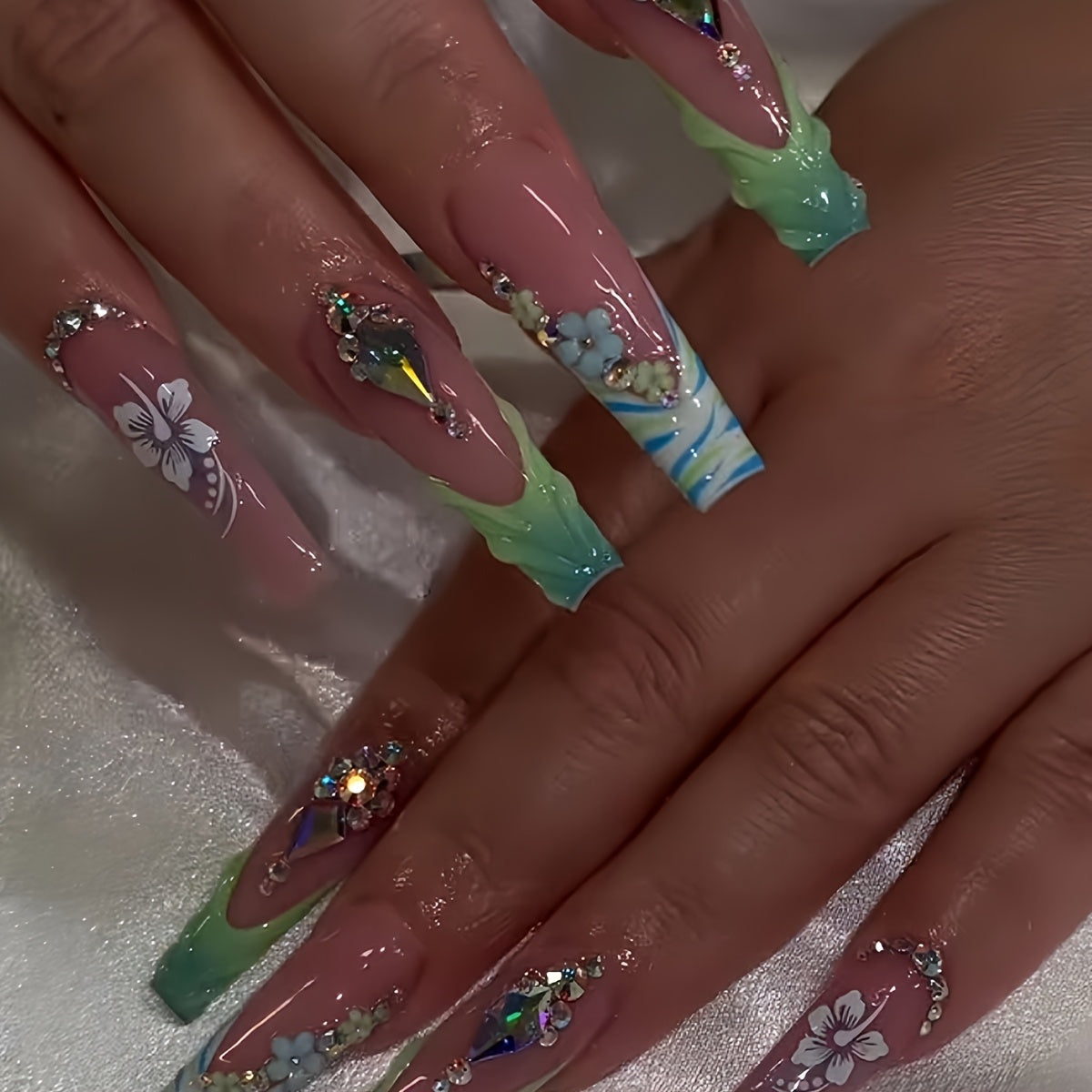 A Set of 24 Press-On Fake Nails Featuring Green 3D Flowers And Rhinestones, Along with Long Ballet-Shaped Nails in Green French Stripes. These Stylish Press-On Nails Come with a Nail File And Jelly Glue, Suitable for Everyday